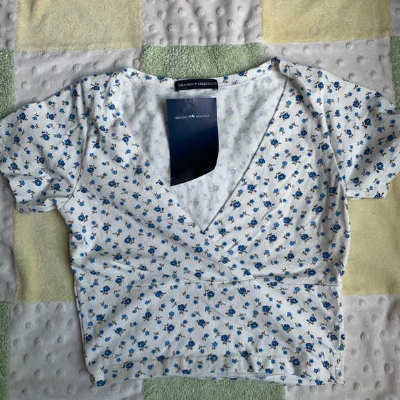 Brandy Melville Tops - 🦋NWT cream Amara with vivid blue/green flowers